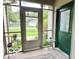 Enclosed porch with a view of the outdoors, featuring a small table and potted plants at 1802 Laurel Dr, Columbus, IN 47203