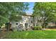 Manicured backyard featuring a wood deck with seating and shade trees at 18112 Kinder Oak Dr, Noblesville, IN 46062