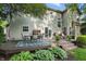 Lovely backyard featuring a wood deck with seating, lush foliage and a manicured lawn at 18112 Kinder Oak Dr, Noblesville, IN 46062