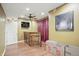 Finished basement with hardwood floors, TV, bar, and curtained window at 18112 Kinder Oak Dr, Noblesville, IN 46062