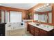 Bathroom with jacuzzi tub, double sink vanity, and tiled floor at 18112 Kinder Oak Dr, Noblesville, IN 46062