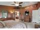 Cozy bedroom with ensuite bathroom, carpeted floors, neutral walls, and a ceiling fan at 18112 Kinder Oak Dr, Noblesville, IN 46062