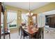 Charming dining room featuring a wooden table set for four, with lots of natural light at 18112 Kinder Oak Dr, Noblesville, IN 46062