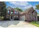 Beautiful two-story brick home with a manicured lawn, a two-car garage, and a concrete driveway at 18112 Kinder Oak Dr, Noblesville, IN 46062