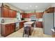 Spacious kitchen with wood cabinets, modern appliances, a central island, and tile flooring at 18112 Kinder Oak Dr, Noblesville, IN 46062