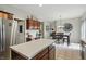 Bright kitchen with white countertops, dark wood cabinets, stainless steel appliances, and a breakfast nook at 18112 Kinder Oak Dr, Noblesville, IN 46062