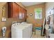 Functional laundry room with a washer, dryer, overhead cabinets, and natural light at 18112 Kinder Oak Dr, Noblesville, IN 46062