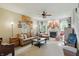 Spacious living room with a cozy fireplace, plush seating, and an abundance of natural light at 18112 Kinder Oak Dr, Noblesville, IN 46062