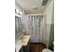 A bathroom featuring a vanity sink and a shower with a decorative curtain at 1908 S Biltmore Ave, Muncie, IN 47302