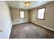 A bedroom with carpet floors and neutral walls with two windows at 1908 S Biltmore Ave, Muncie, IN 47302
