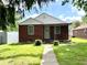 Charming brick home with a well-maintained lawn and inviting entrance at 1908 S Biltmore Ave, Muncie, IN 47302