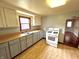 A kitchen with neutral color cabinets, wood countertops, a double sink, and a white gas range at 1908 S Biltmore Ave, Muncie, IN 47302