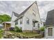 Exterior view of home with stone wall, wooden porch and vinyl siding at 1910 W 10Th St, Anderson, IN 46016