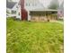 Charming home featuring a covered front porch, well-manicured lawn, and an American flag at 1910 W 10Th St, Anderson, IN 46016