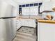 Bright kitchen with stainless steel appliances, white cabinets, and wood countertops at 1910 W 10Th St, Anderson, IN 46016