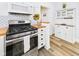 Galley-style kitchen featuring white cabinetry, butcher block countertops, and stainless appliances at 1910 W 10Th St, Anderson, IN 46016