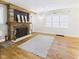 Cozy living room featuring a brick fireplace, wood accent wall, and natural light at 1910 W 10Th St, Anderson, IN 46016