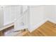 Staircase with white railings and hardwood steps, leading to the upper level at 1910 W 10Th St, Anderson, IN 46016