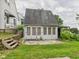 Sunroom with multi-pane windows and a stone patio in a spacious backyard at 1910 W 10Th St, Anderson, IN 46016
