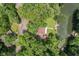 Stunning aerial view of lakefront home with mature trees and private dock and inground pool at 1927 E Derby Ct, Martinsville, IN 46151
