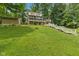 Lush backyard featuring a multi-level deck and stairs leading up to a two-story home at 1927 E Derby Ct, Martinsville, IN 46151