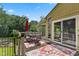 Outdoor deck with a dining set, red umbrella, and a scenic view of the lake at 1927 E Derby Ct, Martinsville, IN 46151