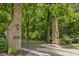 Grand stone entrance marking the entry to a secluded community with mature trees at 1927 E Derby Ct, Martinsville, IN 46151
