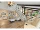 Bright living room with wooden floors, a staircase, modern furniture, and decorative elements at 1927 E Derby Ct, Martinsville, IN 46151