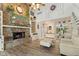 Cozy living room with a stone fireplace, wood floors, and a ceiling fan for relaxed living at 1927 E Derby Ct, Martinsville, IN 46151