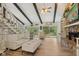 Bright living room with vaulted ceiling, exposed beams, fireplace, and beautiful outdoor views at 1927 E Derby Ct, Martinsville, IN 46151