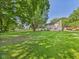 Backyard featuring mature trees and lush green lawn and a fence in the distance at 2126 Tartan Rd, Anderson, IN 46012