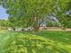 Large backyard featuring mature trees and lush green lawn at 2126 Tartan Rd, Anderson, IN 46012
