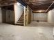 Unfinished basement space showing the stairs and the ceiling structure at 2126 Tartan Rd, Anderson, IN 46012
