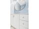 Bathroom vanity with white cabinets, modern round mirror, and chrome faucet at 2126 Tartan Rd, Anderson, IN 46012