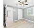 Bright bedroom featuring wood-look floors, a ceiling fan, and fresh paint at 2126 Tartan Rd, Anderson, IN 46012