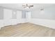 Large bedroom with wood-look flooring, chair railing, and ceiling fan at 2126 Tartan Rd, Anderson, IN 46012