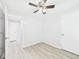 Bedroom with ceiling fan, neutral walls, and wood-look flooring at 2126 Tartan Rd, Anderson, IN 46012