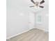 Bedroom with wood-look floors, ceiling fan, and bright natural light from the window at 2126 Tartan Rd, Anderson, IN 46012