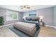 Nicely staged primary bedroom with big windows and a ceiling fan at 2126 Tartan Rd, Anderson, IN 46012