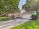 Traditional two-story home featuring an attached garage and a concrete driveway at 2126 Tartan Rd, Anderson, IN 46012