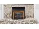 Close up of the stone fireplace with a black metal grate at 2126 Tartan Rd, Anderson, IN 46012