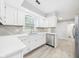 Bright kitchen with white cabinets, stainless steel appliances, and stone countertops at 2126 Tartan Rd, Anderson, IN 46012