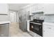 Kitchen featuring stainless steel refrigerator and oven against white cabinets at 2126 Tartan Rd, Anderson, IN 46012