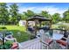 Backyard patio with a gazebo and outdoor seating arrangement, perfect for relaxation and outdoor entertaining at 2608 E 500 N, Whiteland, IN 46184