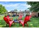 Backyard featuring a cozy firepit area with red Adirondack chairs and a charming gazebo at 2608 E 500 N, Whiteland, IN 46184