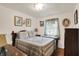 A cozy bedroom features a vintage bed with patterned quilt and light walls with vintage decor at 2608 E 500 N, Whiteland, IN 46184