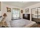 A cozy bedroom featuring a vintage bed with patterned quilt and light walls with vintage decor at 2608 E 500 N, Whiteland, IN 46184