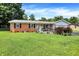 Charming brick home with a well-manicured lawn, flowerbeds, and a welcoming front porch at 2608 E 500 N, Whiteland, IN 46184