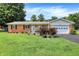 Charming brick home with a well-manicured lawn, flowerbeds, and an attached two-car garage at 2608 E 500 N, Whiteland, IN 46184