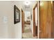 Hallway featuring neutral walls, wood trim, and glimpses of the living room, creating a seamless flow at 2608 E 500 N, Whiteland, IN 46184